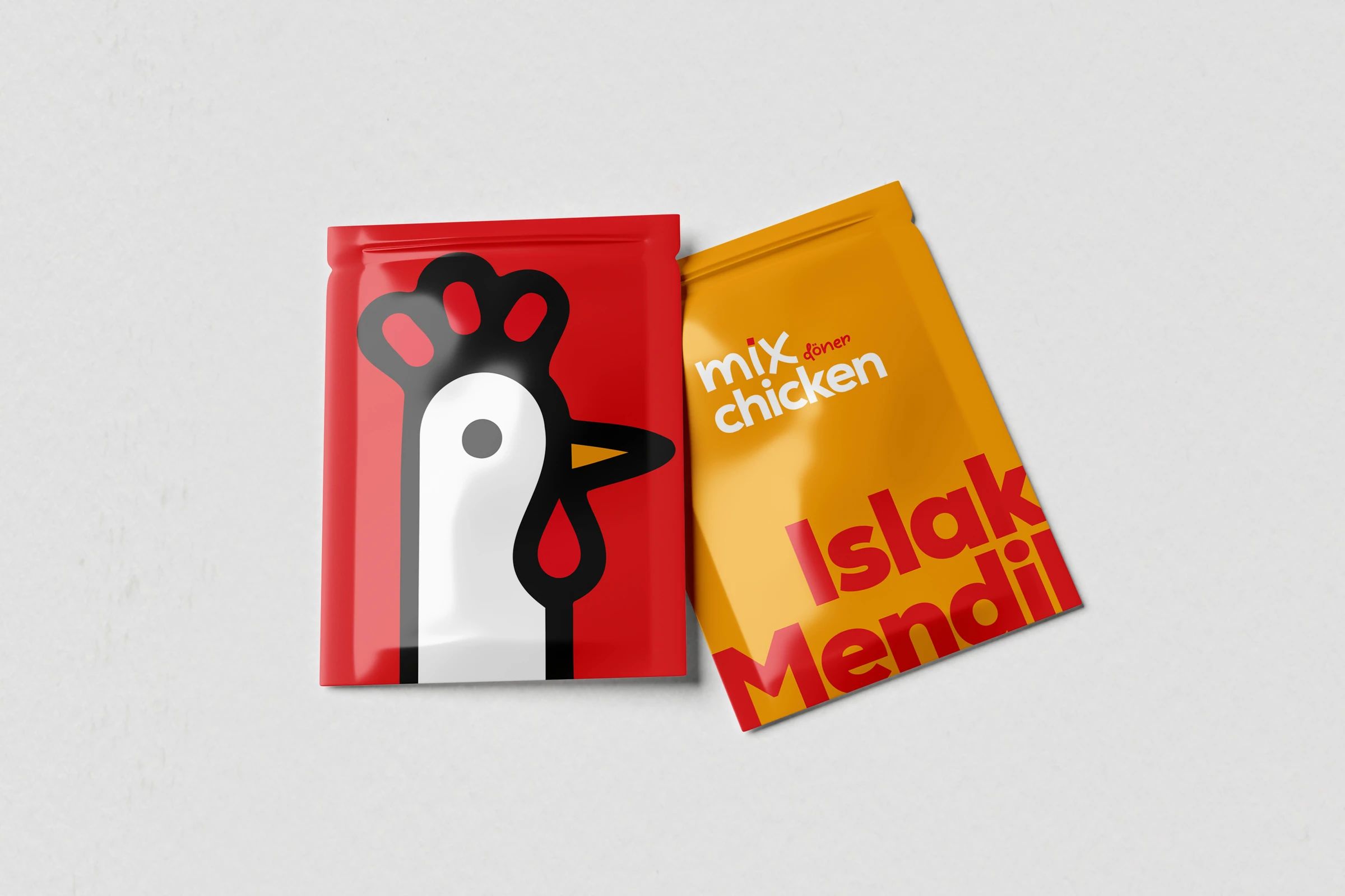 Two Mix Chicken wet wipe sachets, one red with the character and one yellow reading “Islak Mendil”